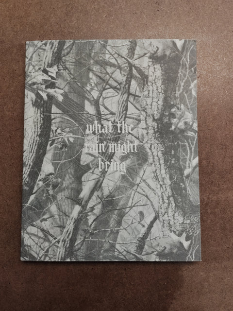 A square art print or book cover featuring a grayscale camouflage-style forest tree pattern with the text 'what the rain might bring' in the center, placed on a brown textured surface.